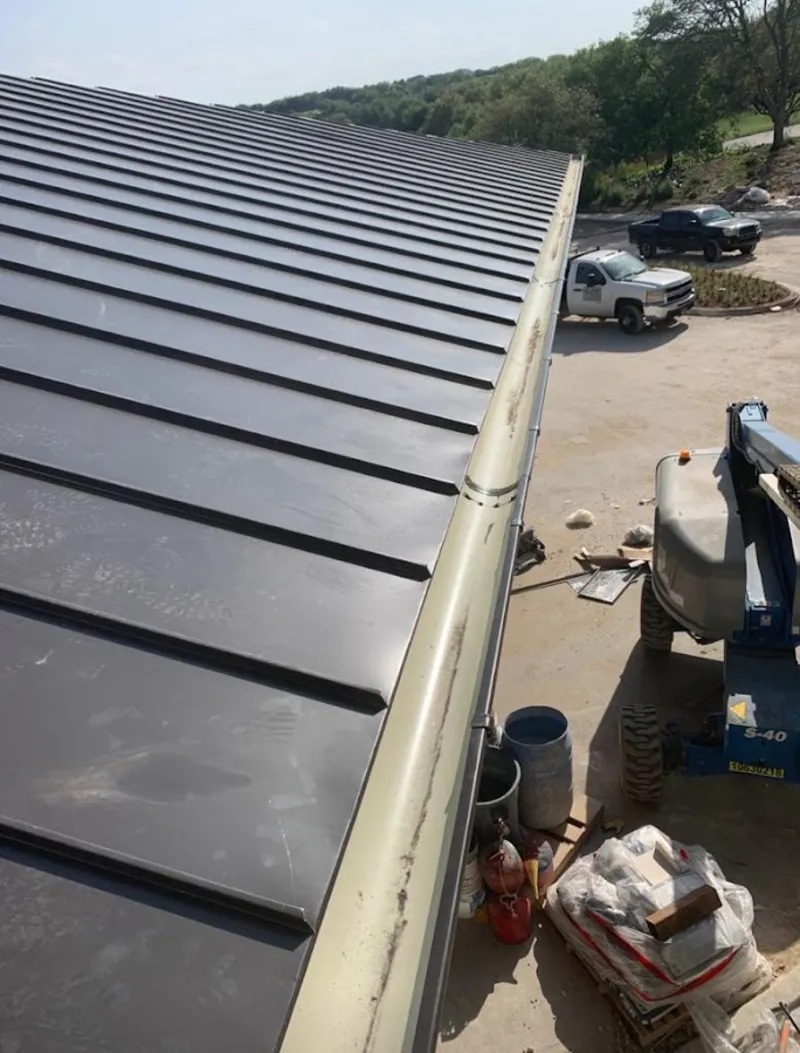 Standing seam panel and gutter detail on a metal roofing jobsite in Garden City